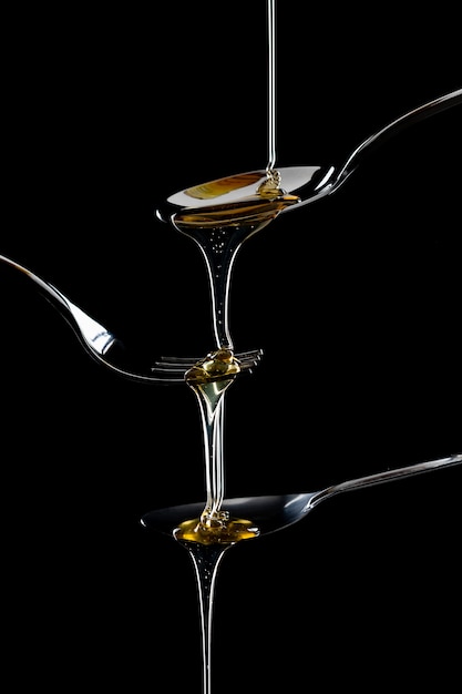 Free photo golden sweet honey dripping from spoon