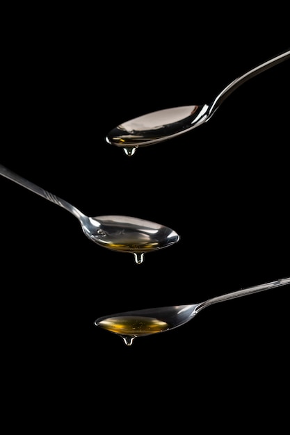 golden sweet honey dripping from spoon 