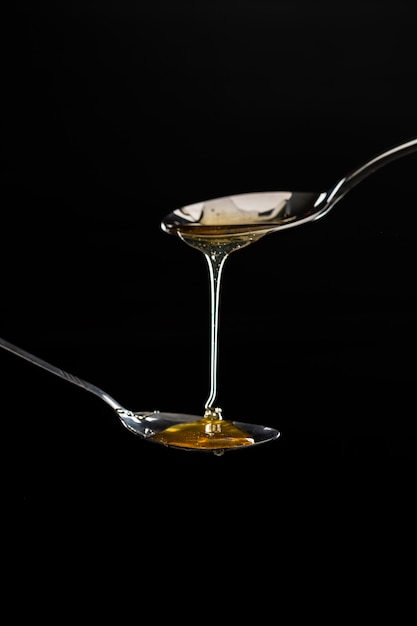 Free photo golden sweet honey dripping from spoon