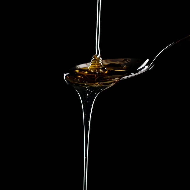 Free photo golden sweet honey dripping from spoon