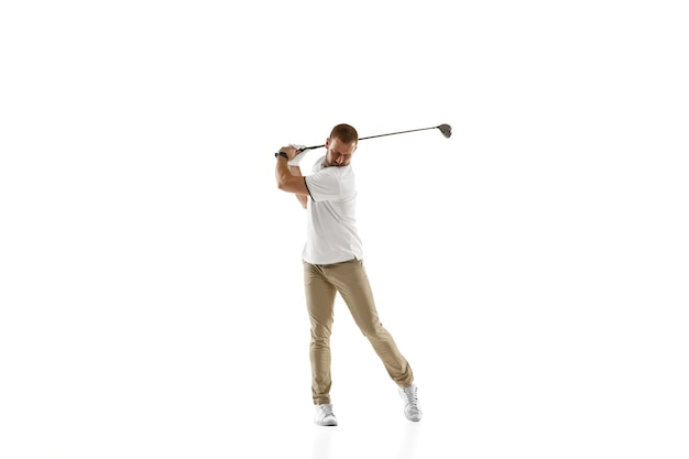 Free photo golf player in a white shirt taking a swing isolated on white  wall with copyspace. professional player practicing with bright emotions and facial expression. sport concept.