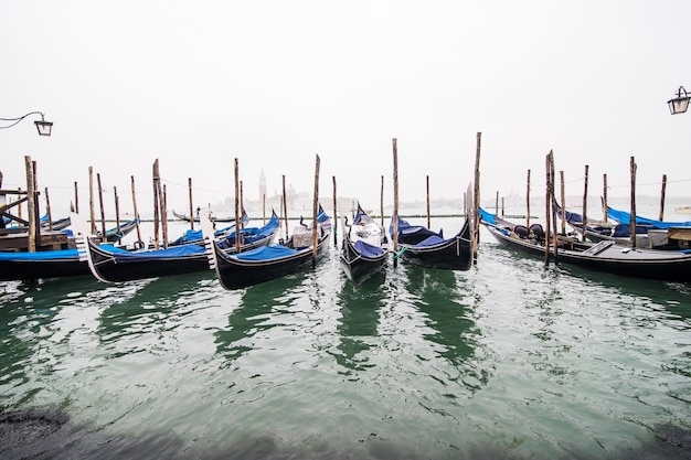 Gondolas in lagoon of Venice on sunrise, Italy