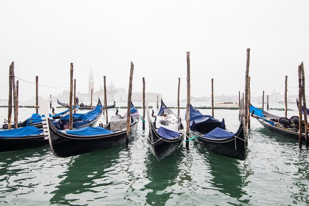 Gondolas in lagoon of Venice on sunrise, Italy