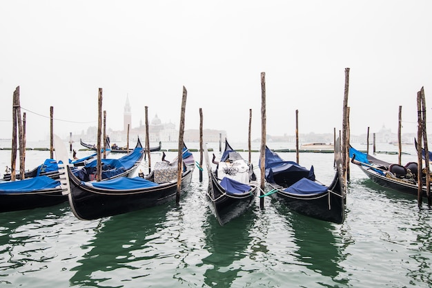 Gondolas in lagoon of Venice on sunrise, Italy