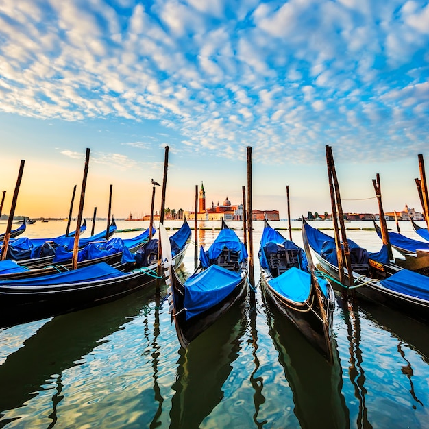 Free Photo gondolas in lagoon of venice on sunrise, italy