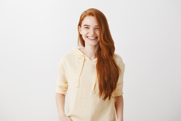 Good-looking redhead woman smiling with white teeth, feeling happy