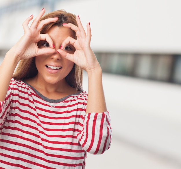 Free Photo good-looking woman with hand binoculars