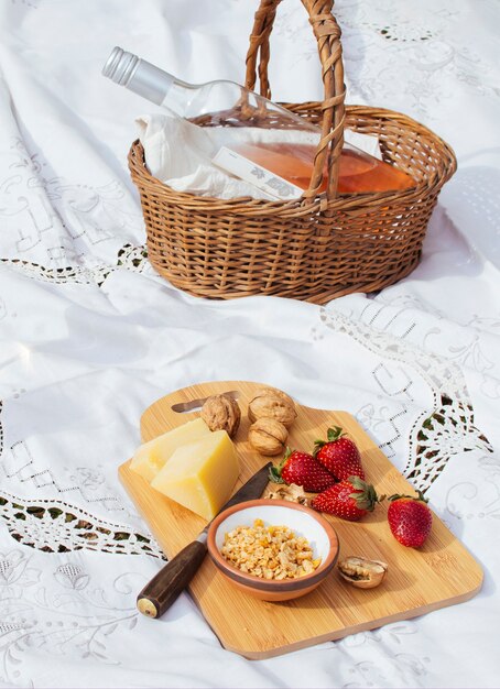 Goodies on chopping board next to straw basket