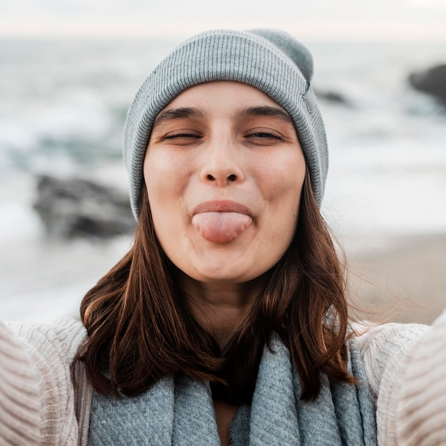 Goofy woman taking a selfie at the beach