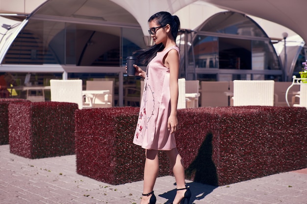 Free photo gorgeous asian woman in fashion dress on terrace of the restaurant