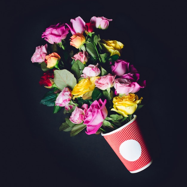 Gorgeous bouquet of colorful roses put in red paper cup