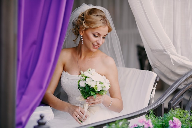 Free Photo gorgeous bride holding her bouquet