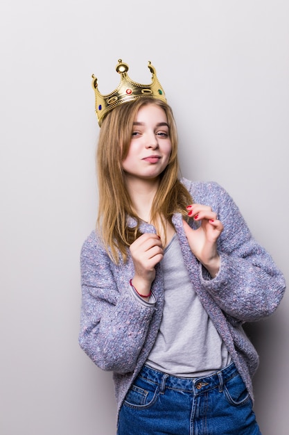 Free photo gorgeous girl holding crown on head