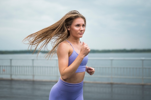 Free photo gorgeous woman running medium shot