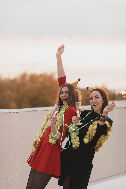 Free photo gorgeous women having fun on the rooftop party