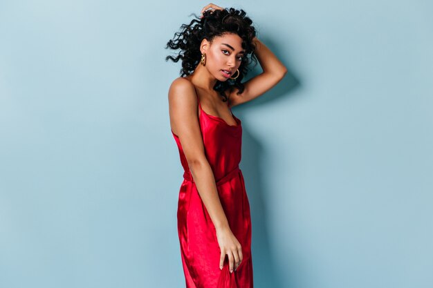 Gorgeous young woman touching curly hair