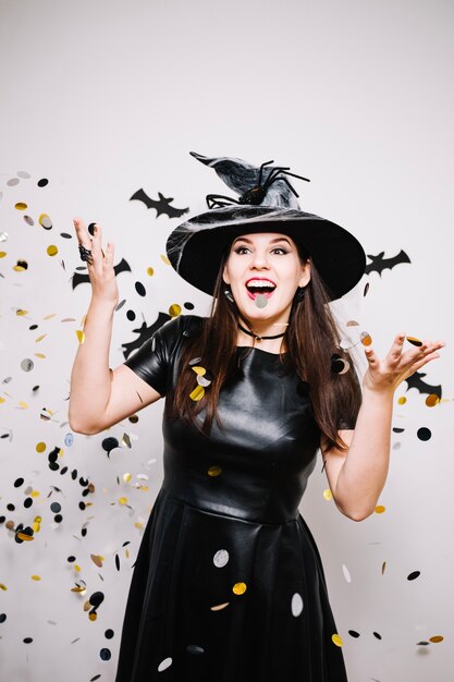 Gothic woman throwing colorful confetti