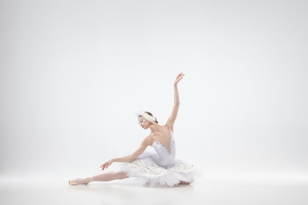 Graceful classic ballerina dancing isolated on white  background.