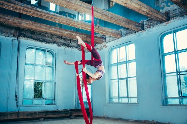 Graceful gymnast performing aerial exercise