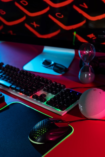 Free photo gradient illuminated neon gaming desk setup with keyboard