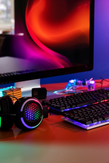 Free photo gradient illuminated neon gaming desk setup with keyboard