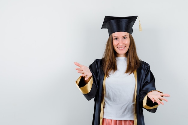 Graduate woman giving hug at camera in casual clothes, uniform and looking merry. front view.