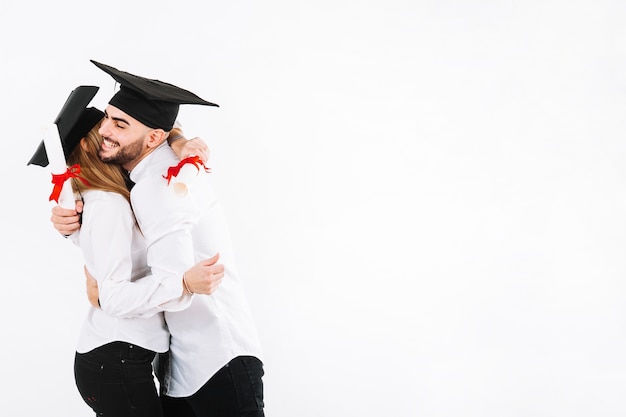 Graduating couple embracing