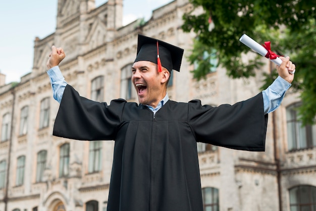 Graduation concept with portrait of happy man