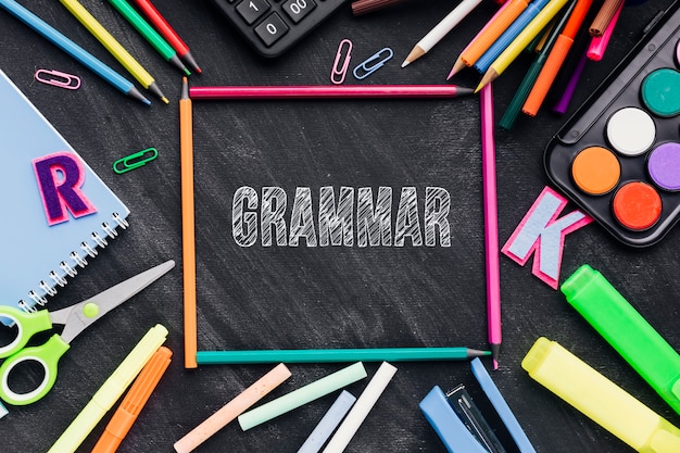 Grammar word on chalkboard with school supplies