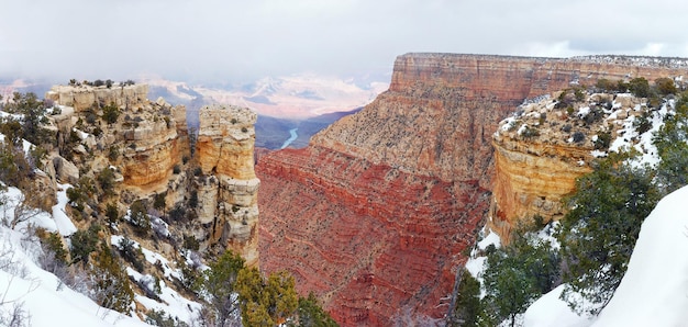 Grand Canyon panorama view in winter with snow and clear blue sky.