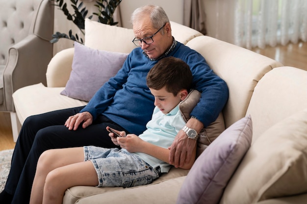 Grandchild and grandfather relaxing on the couch