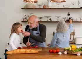 Free photo grandma and grandpa cooking together with grandkid