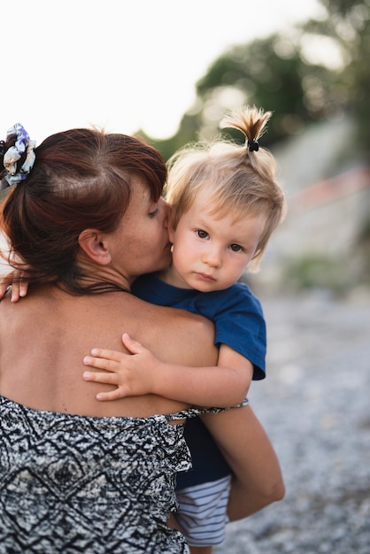 Grandma holding and kissing grandson