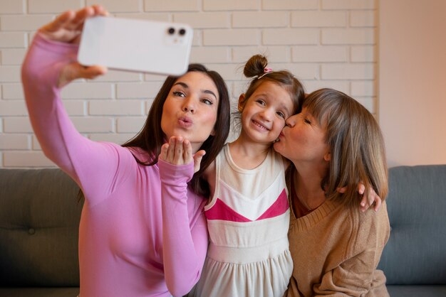 Grandmother being kissed on the cheek by family