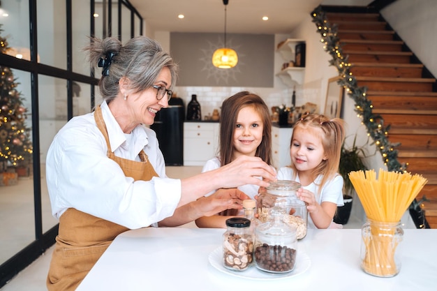 Grandmother and granddaughter are cooking on kitchen