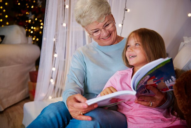 Grandmother and  granddaughter having a fun in bedroom