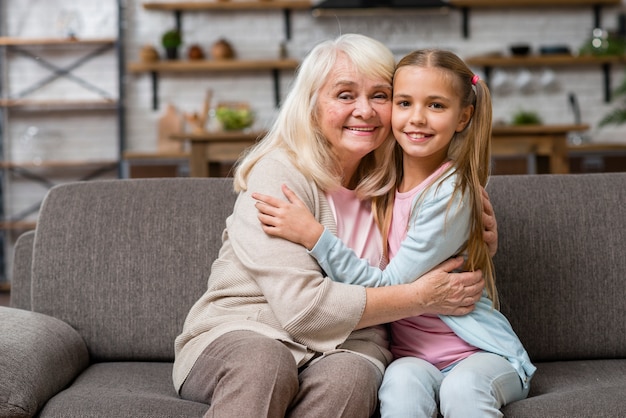 Grandmother and granddaughter hugging front view