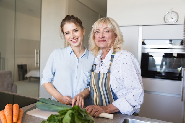 Free photo grandmother and granddaughter making healthy food together