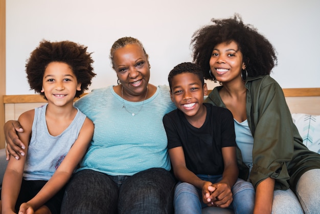 Grandmother, mother and children together at home.