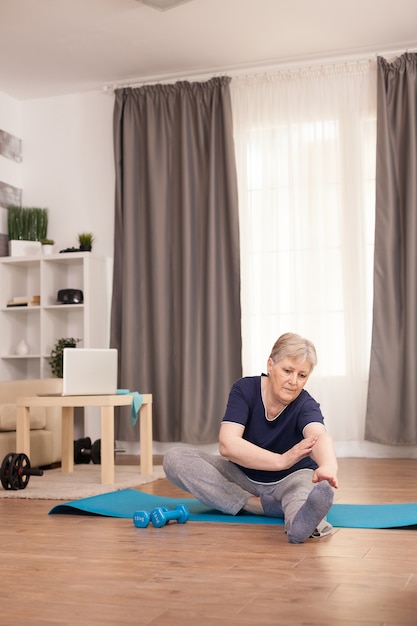 Grandmother with a healty lifestyle doing streching training