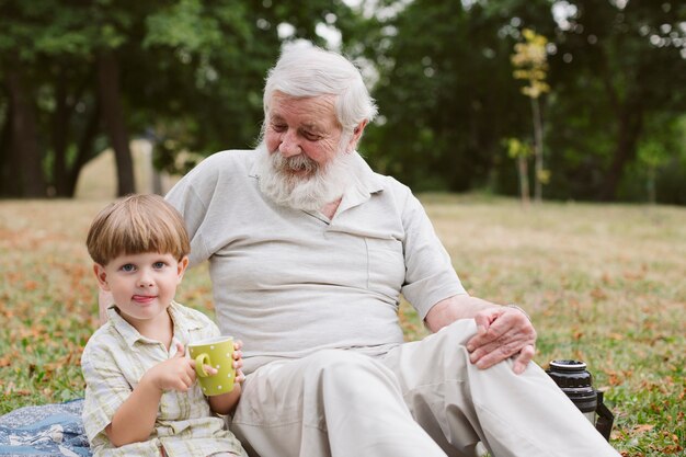 Grandpa and grandson at picnic in park