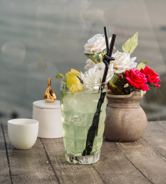 grape water garnished with grape pieces, ice, and flower