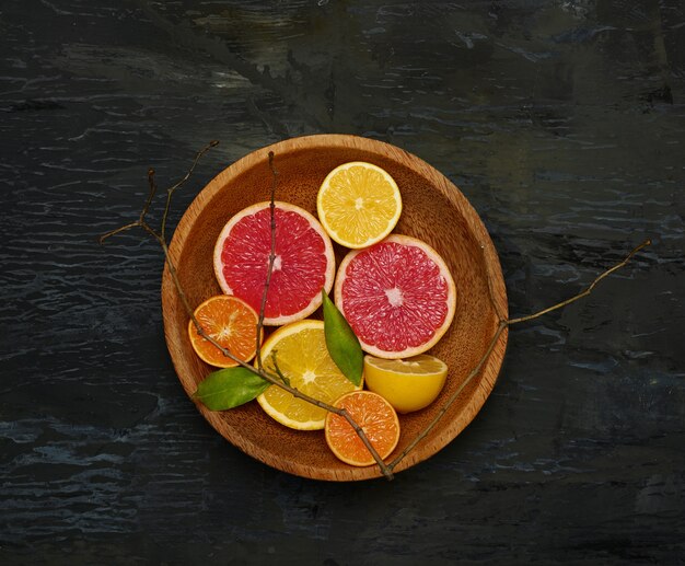 Grapefruit citrus fruit halves on wooden plate