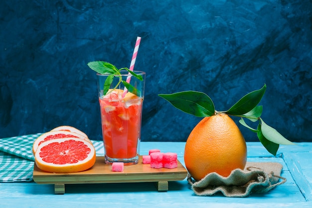 Grapefruit and drink with picnic cloth