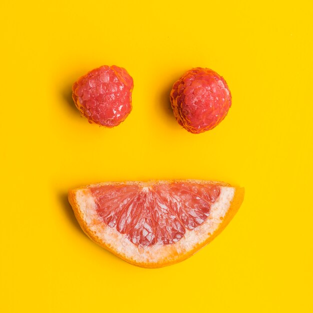 Grapefruit and raspberries in form of smile