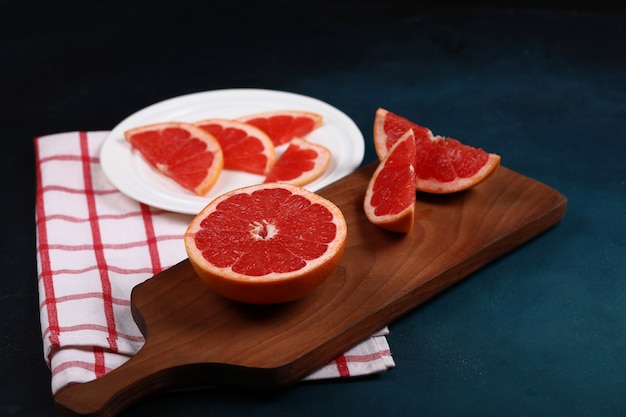 Grapefruit sliced on the wooden board.