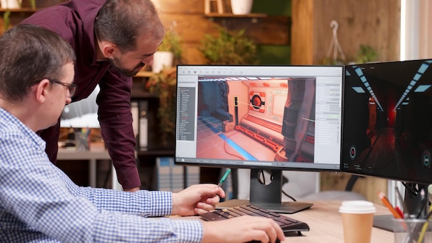 Free photo graphic designer in gaming industry talking detail with his colleague analyzing 3d design level explaining production creative ideas. game creators working at videogame illustration in company office