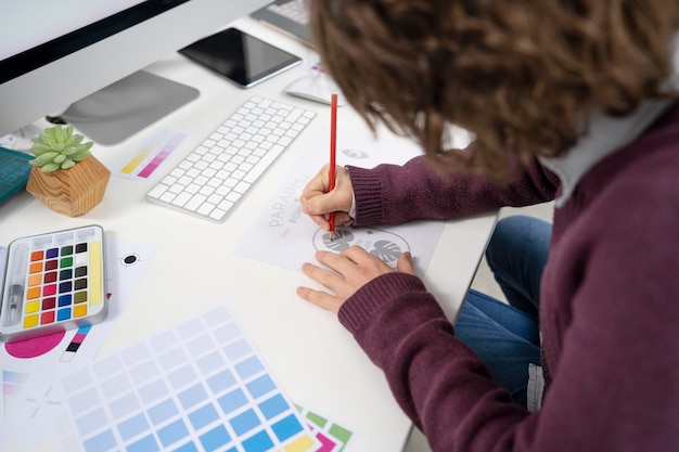 Graphic designer making a logo on a notebook