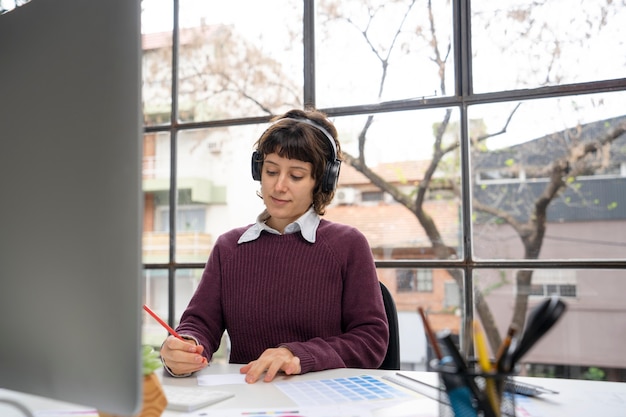 Graphic designer making a logo on a notebook