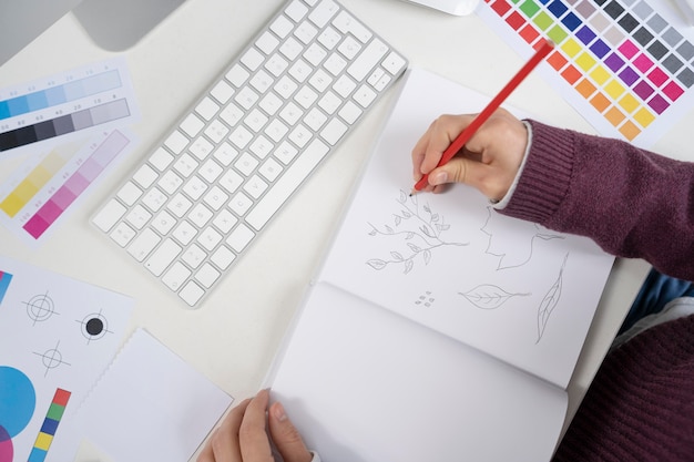 Graphic designer making a logo on a notebook